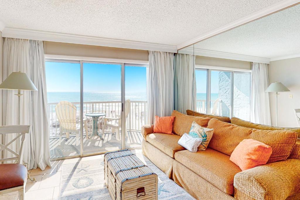 a living room with a couch and a view of the ocean at Islander W 304 in Fort Walton Beach