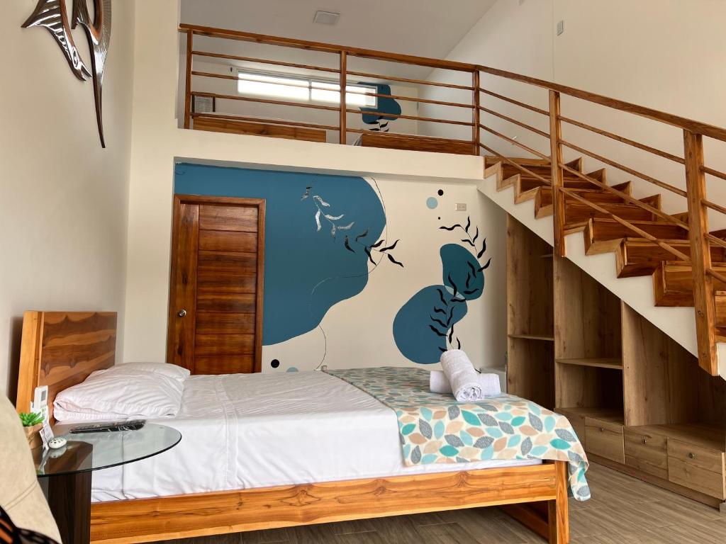 a bedroom with a bunk bed and a staircase at Ohana Beach Hotel in Playas