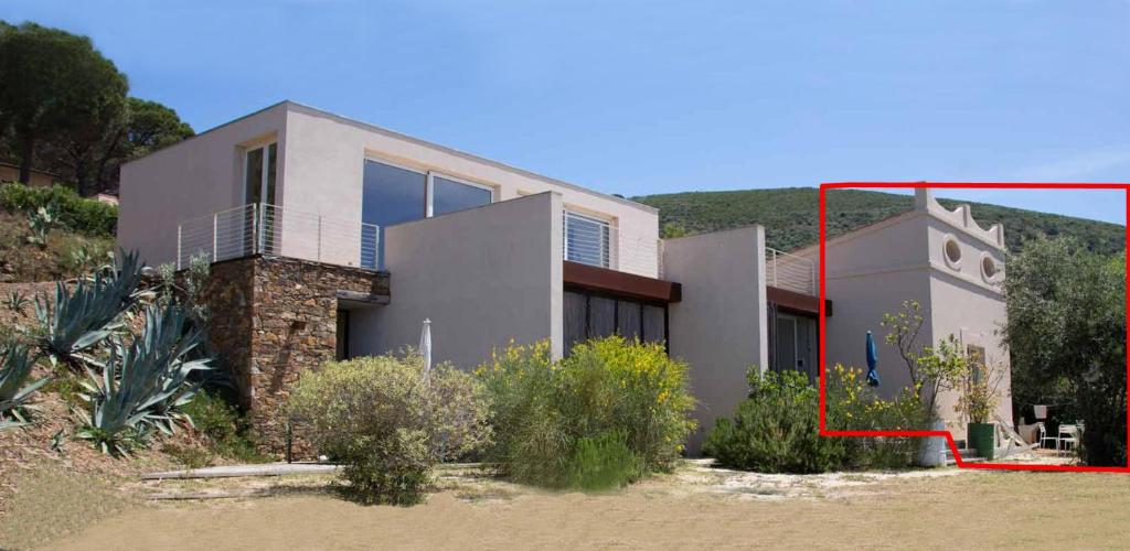 a house with a red box in front of it at Casottino presso residenza Rosso di Sera in Capoliveri