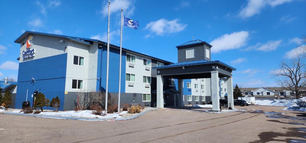a blue and white building with a flag at Comfort Inn & Suites in Shakopee