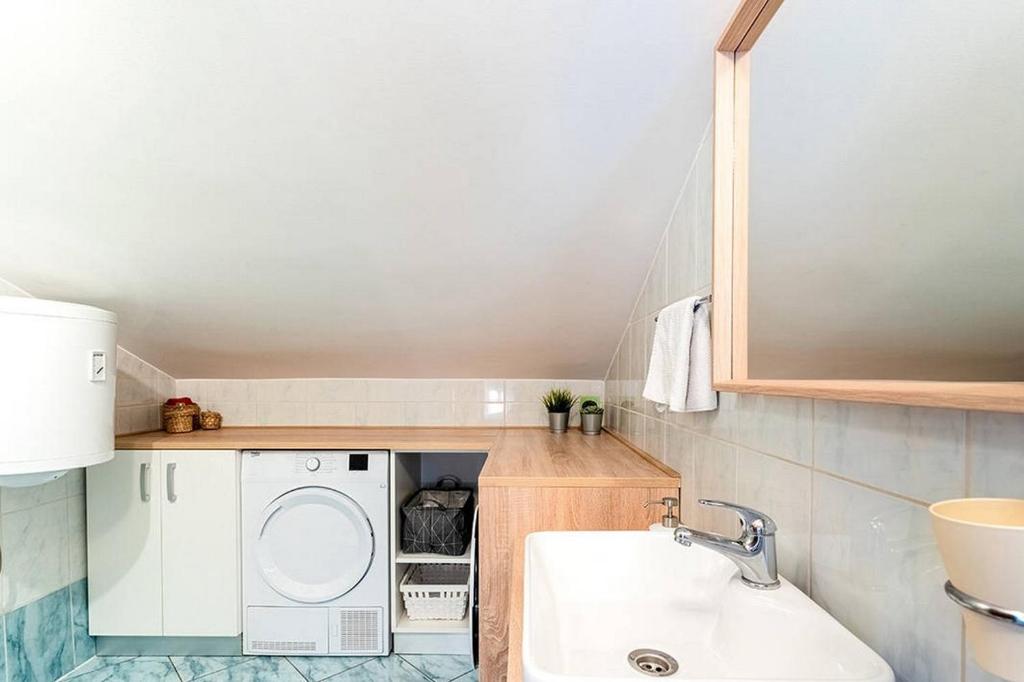 a small bathroom with a washing machine and a sink at Apartments by the sea Cres - 8095 in Cres
