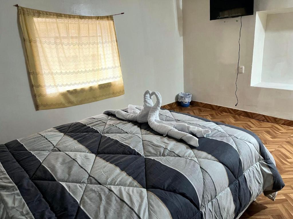 Postel nebo postele na pokoji v ubytování Hospedaje Rumiñahui