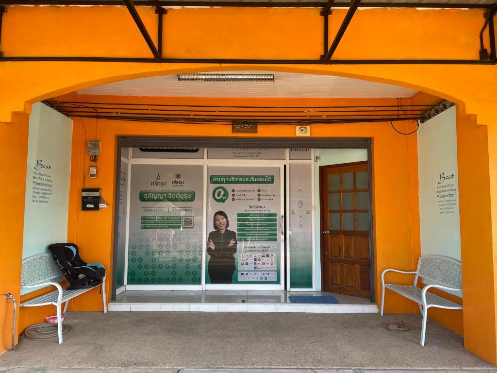 an orange building with two chairs in front of it at Best Rent a Room in Nai Yang Beach