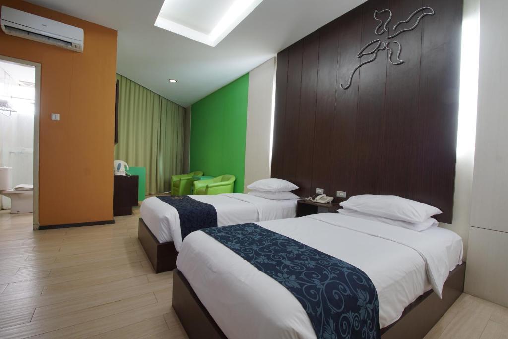 Postel nebo postele na pokoji v ubytování Hotel New Puri Garden