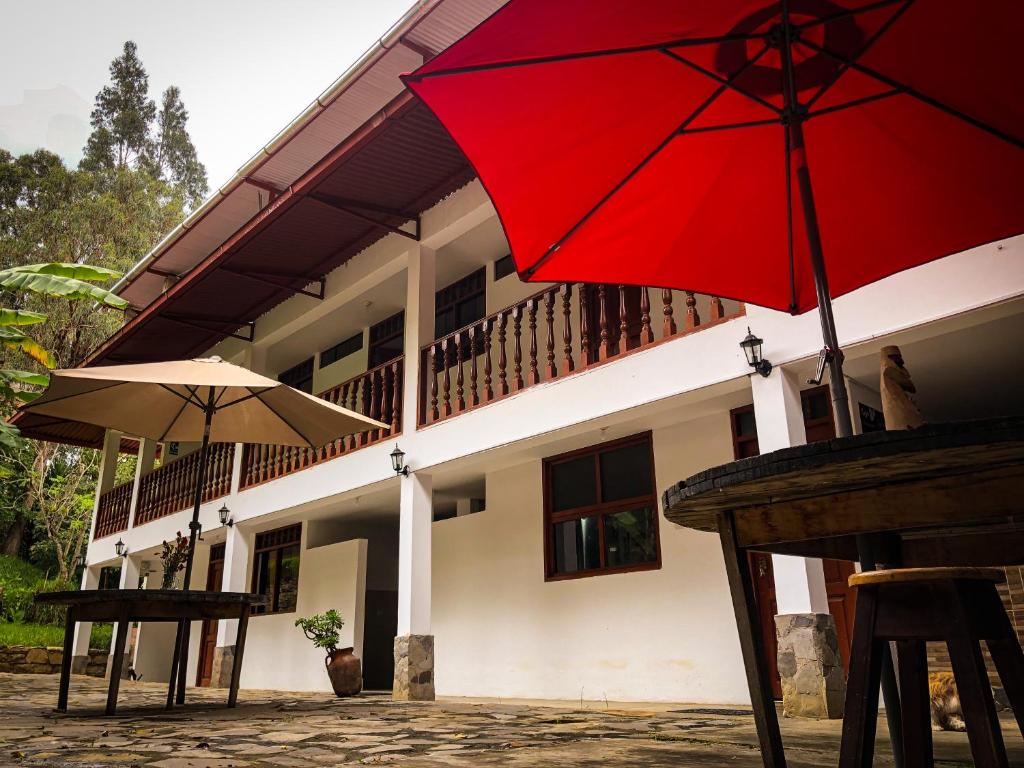 two red umbrellas sitting outside of a building at Killa Wasi B&B in Chachapoyas