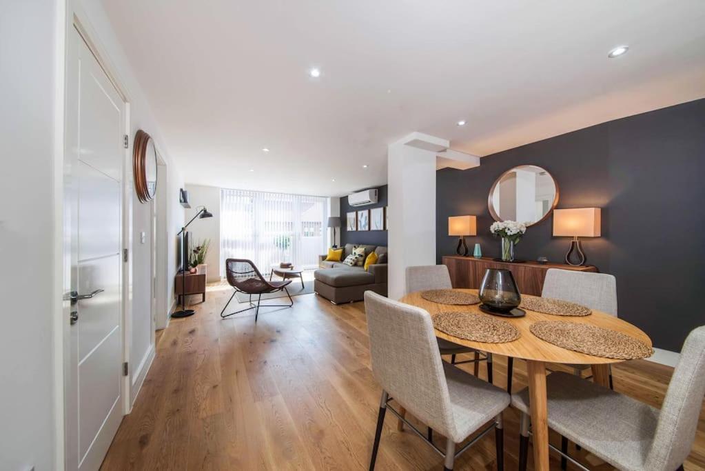 a dining room and living room with a table and chairs at Number 7 Borough Apartments 2 Bed 2 Bath in London