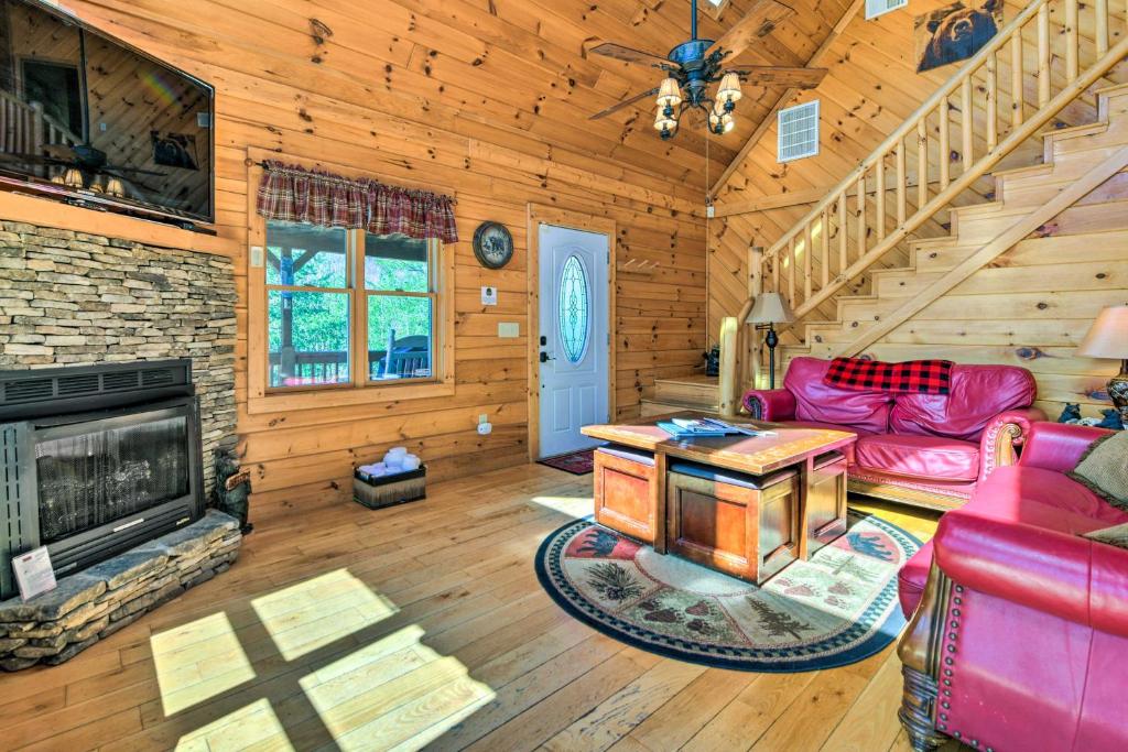 a living room with a couch and a fireplace at Bryson City Cabin Rental with Mountain View, Hot Tub in Bryson City