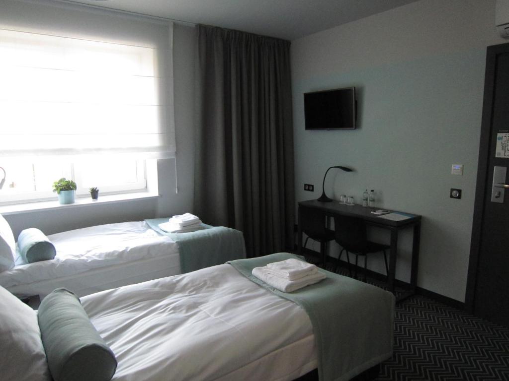 Postel nebo postele na pokoji v ubytování So Stay Hotel