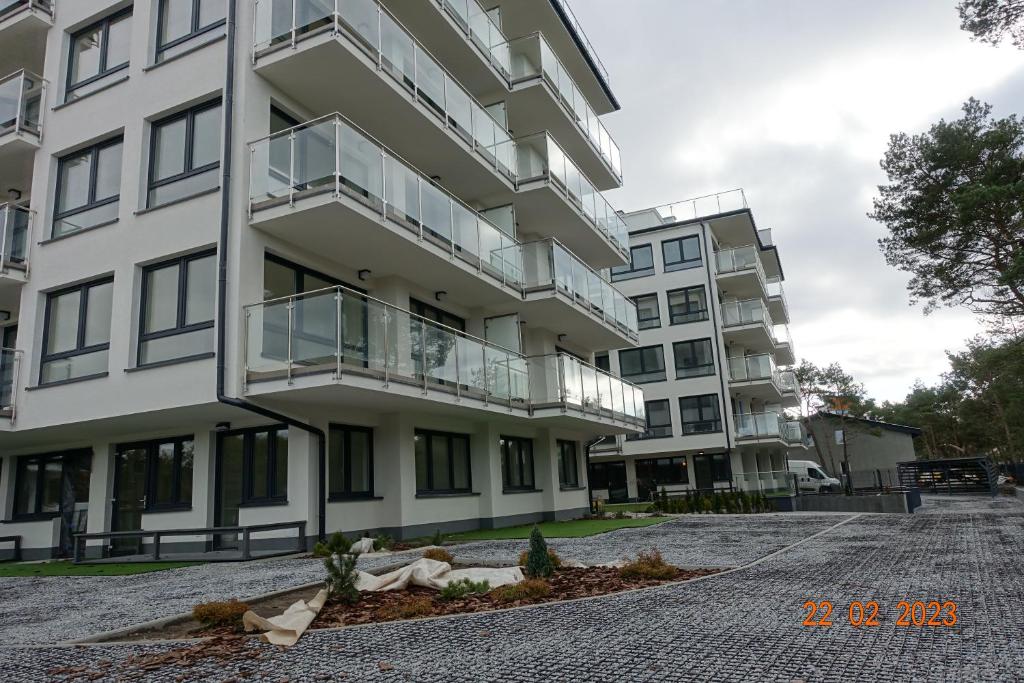 an apartment building with a balcony on a street at APARTAMENT PRZY PLAŻY 2 in Rowy