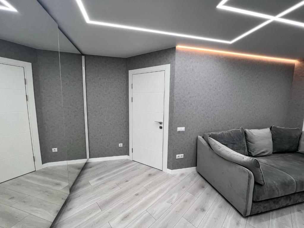 a living room with a couch and a door at Modern Gagarina Avenue in Dnipro