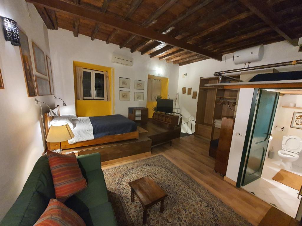 a living room with a bed and a couch at Appartamenti Gardenia in Rome