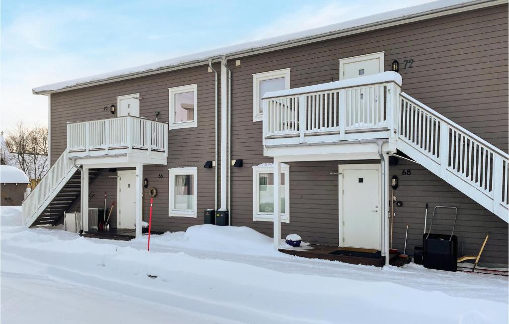 a apartment building with a staircase on the side of it at Gorgeous Apartment In Rros With Kitchen in Røros