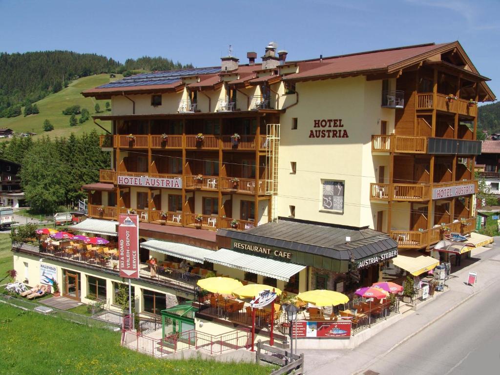 an aerial view of a hotel with tables and umbrellas at Hotel Austria in Niederau