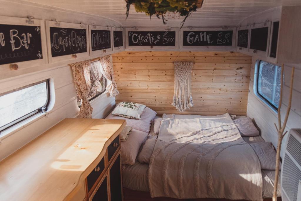 a bedroom with two beds in a rv at Caravan on Ranch in Třebívlice