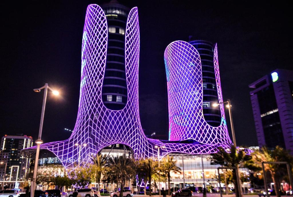 a building with a purple object in front of it at Century Marina Hotel - Lusail in Lusail