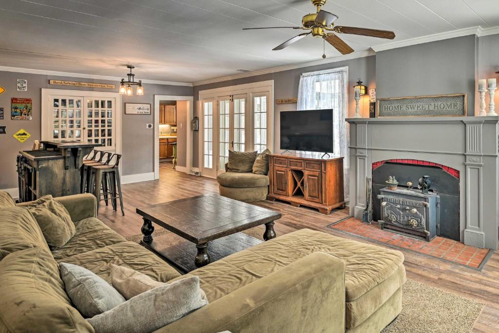 a living room with a couch and a fireplace at Forestport Home with Access to Otter Lake in Forestport