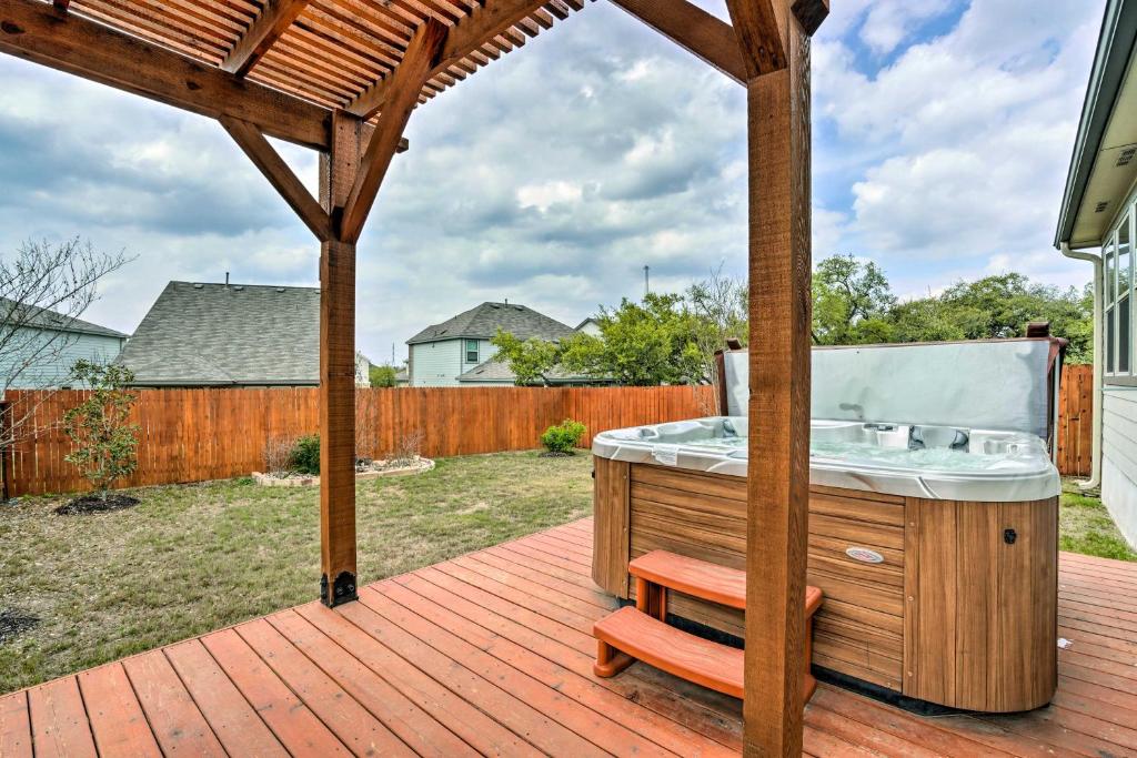 a wooden deck with a hot tub on a patio at San Antonio Vacation Rental with Hot Tub, Yard! in Selma