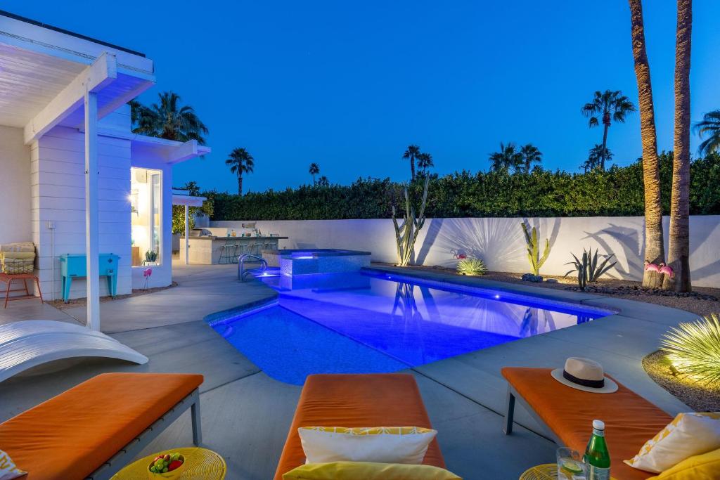 a swimming pool in the backyard of a house at For The Record in Palm Springs