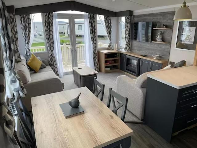 a living room with a table and a couch at Whitstable retreat in Seasalter