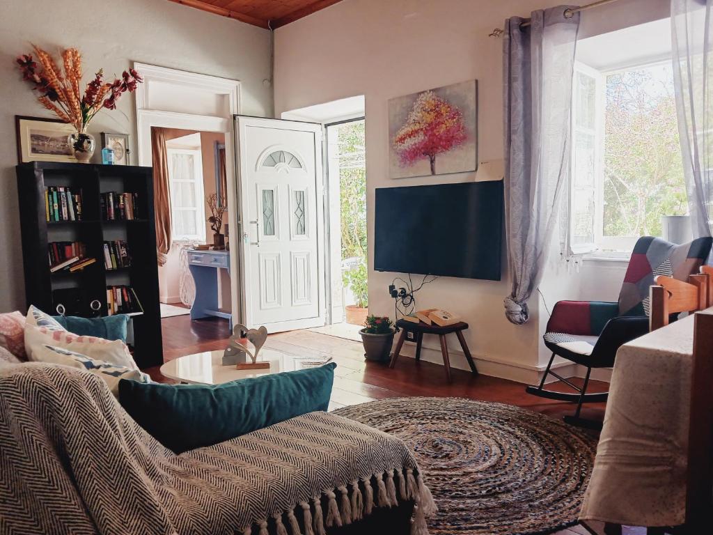 a living room with a couch and a tv at Fairytale in Boïkátika