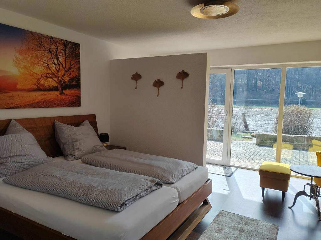 a bedroom with a bed and a large window at Ferienwohnung Elbtraum in Pirna