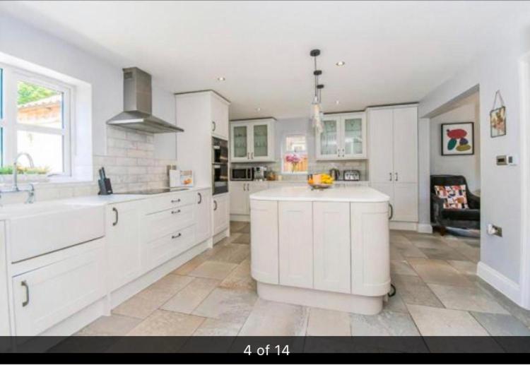 a large kitchen with white cabinets and a sink at Luxury Tydd St Giles Holiday Rental in Tydd Saint Giles