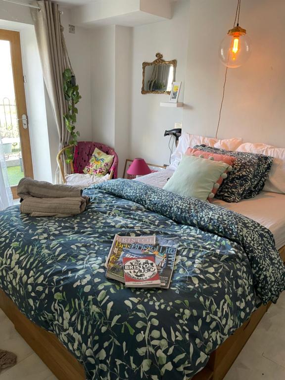 a bedroom with a bed with a book on it at The Cottage, Ashfield Place in Bristol