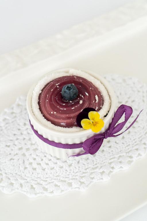 a chocolate dessert on a white plate with flowers at Hotel Grahor Depandance in Sežana
