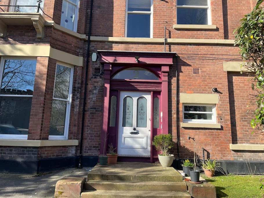 a red brick house with a white door at Stunning Liverpool Apartment in Liverpool