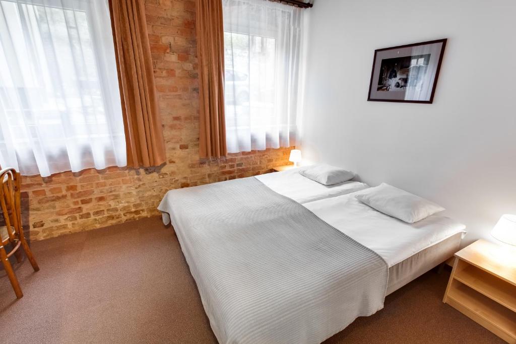Postel nebo postele na pokoji v ubytování Janne Hotel