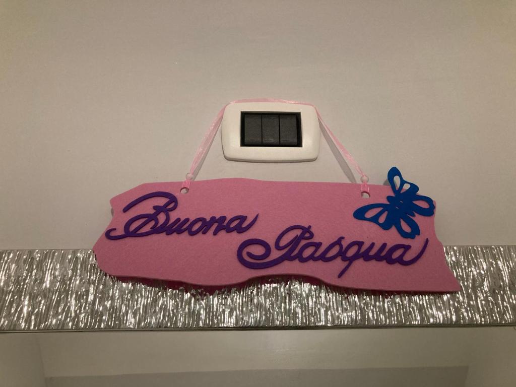 a cake with a sign on top of a counter at Casa Gio’ in Naples