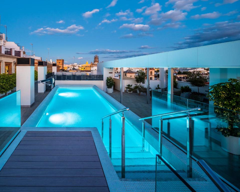 a swimming pool on the roof of a building at nQn Aparts & Suites Sevilla in Seville
