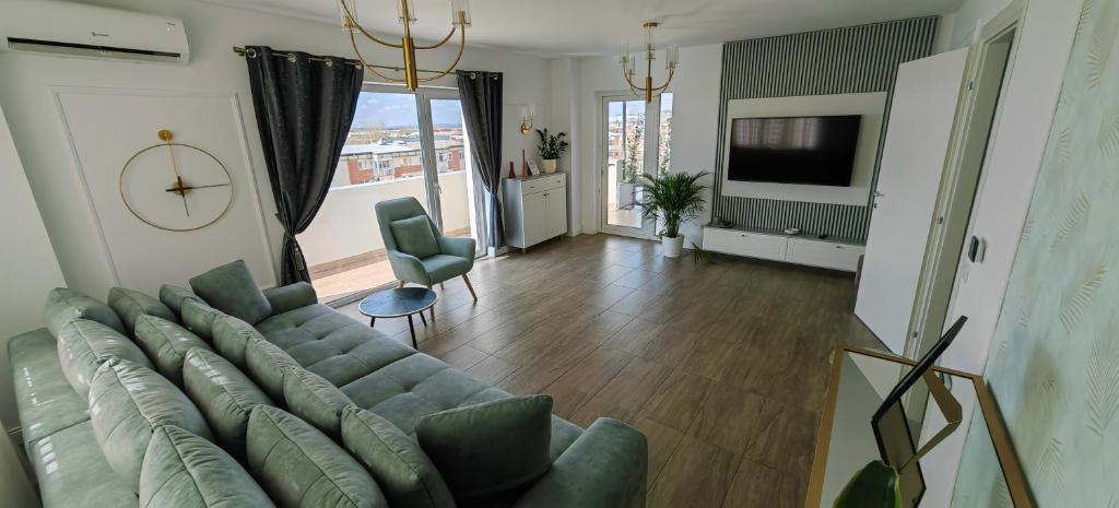 a living room with a couch and a television at Luxury apartment Private parking self check-in51 in Craiova