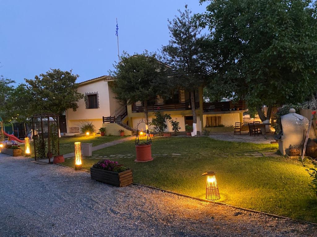 a yard with lights on the grass in front of a house at VILLA PITI in Elaiokhórion
