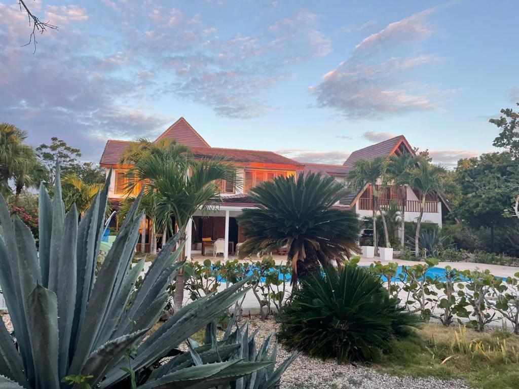 a resort with palm trees and chairs and a building at Río Mar Cumayasa in La Romana