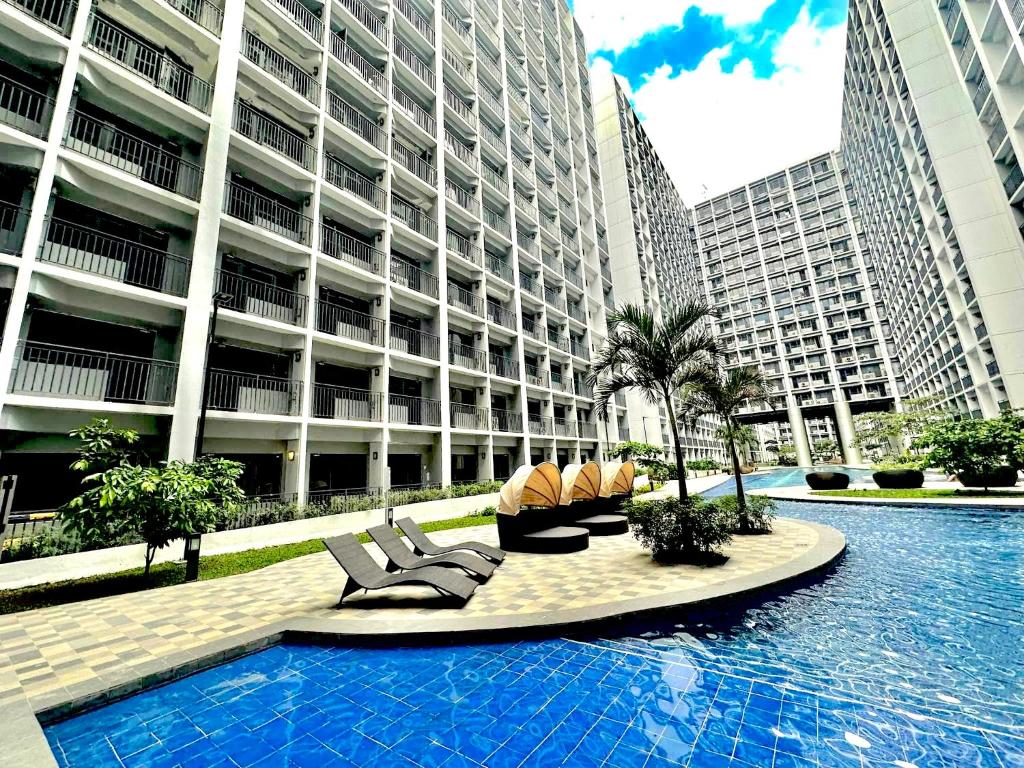 a swimming pool in the middle of a large building at Resort Style Condo Walkable to Mall of Asia in Manila
