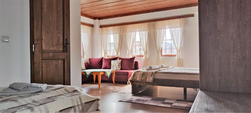 - une chambre avec un lit et un canapé dans l'établissement Chardaka Guest House, à Kalofer