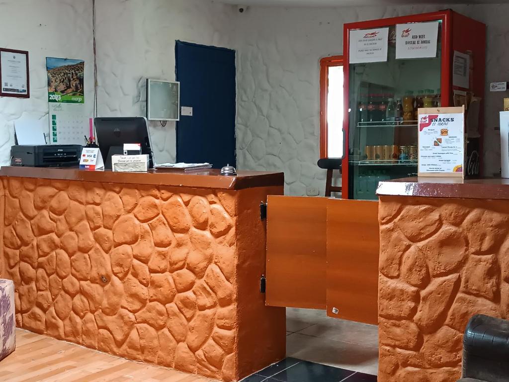 a counter in a store with a cash register at El ZORZAL in Salento