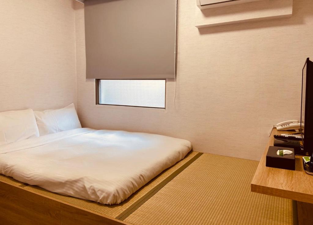 Postel nebo postele na pokoji v ubytování Beauty Garden Hotel - Jiaoxi