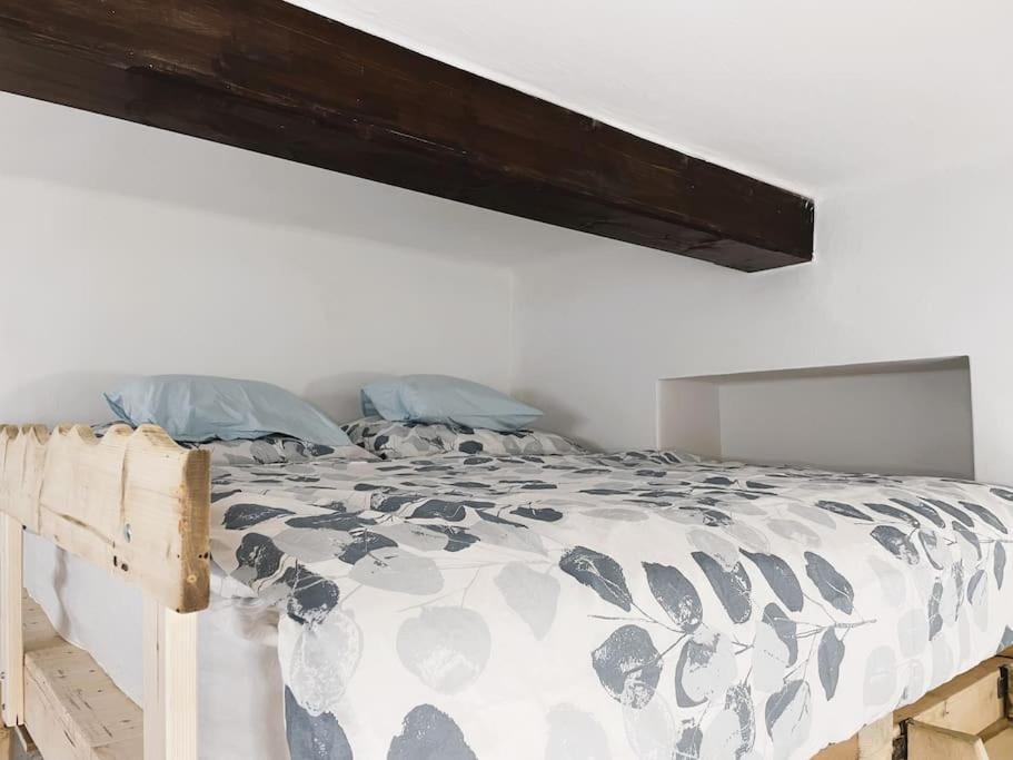 Ce lit se trouve dans une chambre blanche dotée d'une tête de lit en bois. dans l'établissement Flat white flat, à Prague