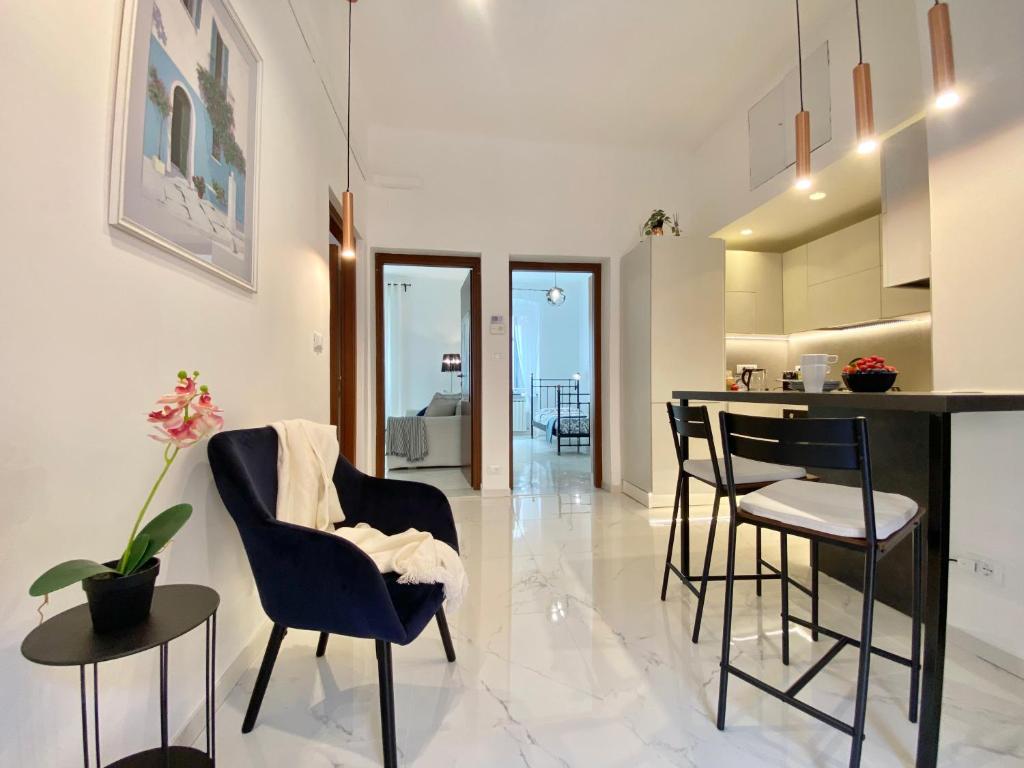 a kitchen and living room with a table and chairs at TERMINAL Apartment in Genova