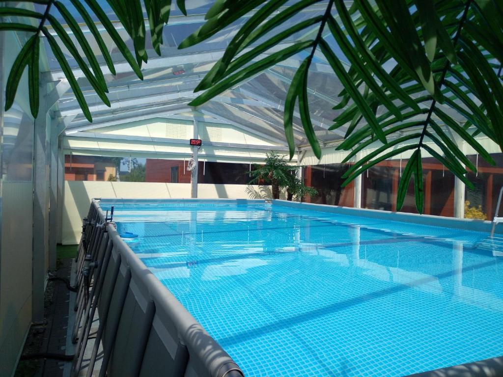 a swimming pool on the roof of a building at Domki Kamila in Grzybowo