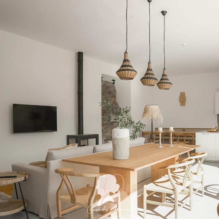 a living room with a wooden table and chairs at Casa das Marucas in Peso da Régua