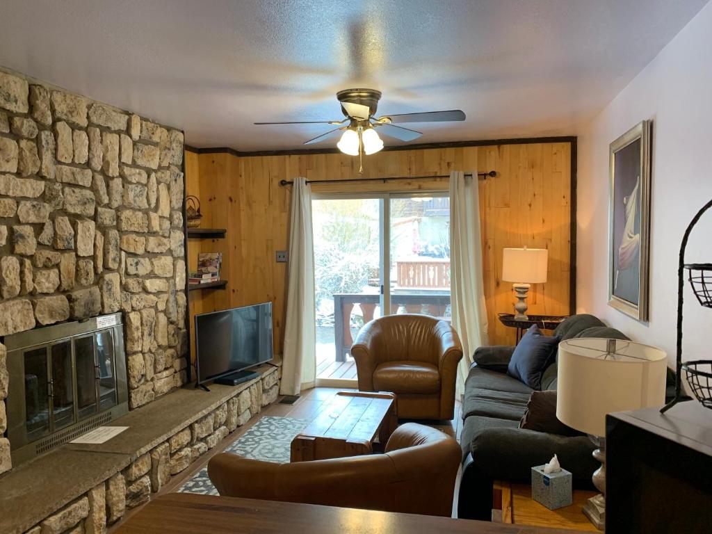 a living room with a couch and a fireplace at Telemark #4 Townhouse On The River in Red River