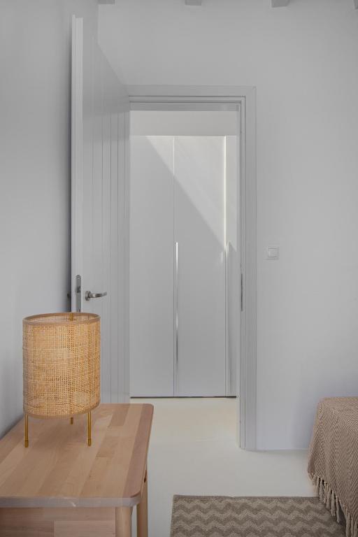 a room with a table and a sliding glass door at Blue Sea Villa in Serifos Chora