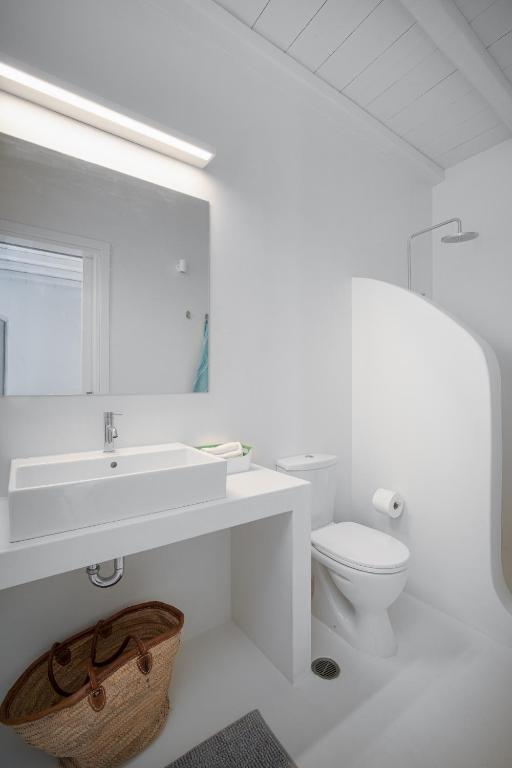 a white bathroom with a sink and a toilet at Blue Sea Villa in Serifos Chora