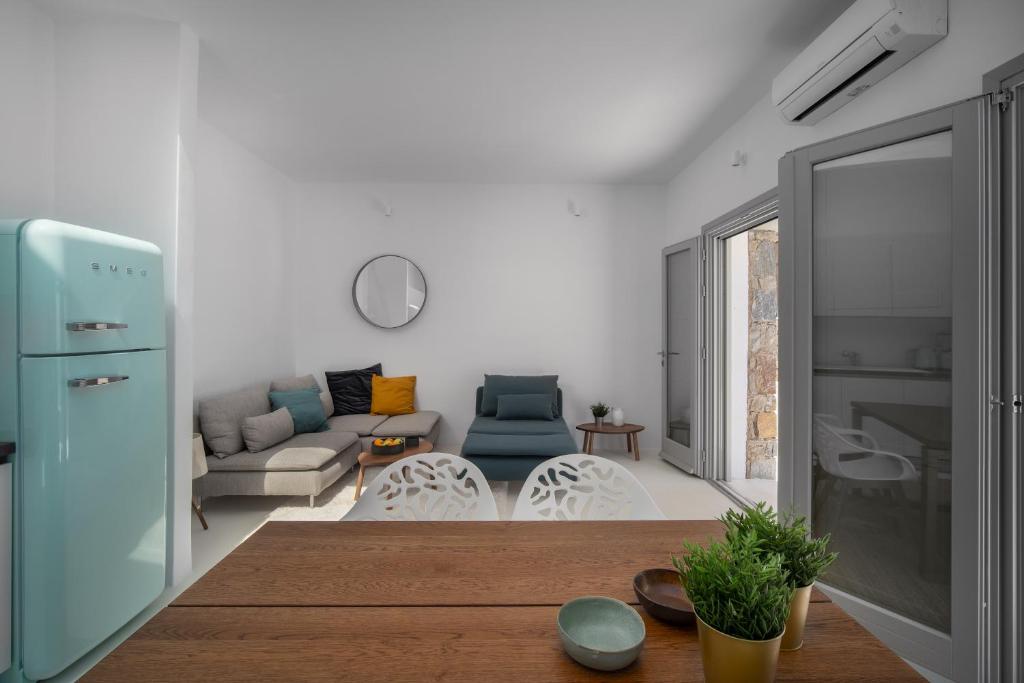 a living room with a couch and a table at Blue Sea Villa in Serifos Chora
