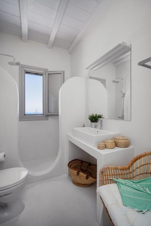 a white bathroom with a sink and a toilet at Blue Sea Villa in Serifos Chora
