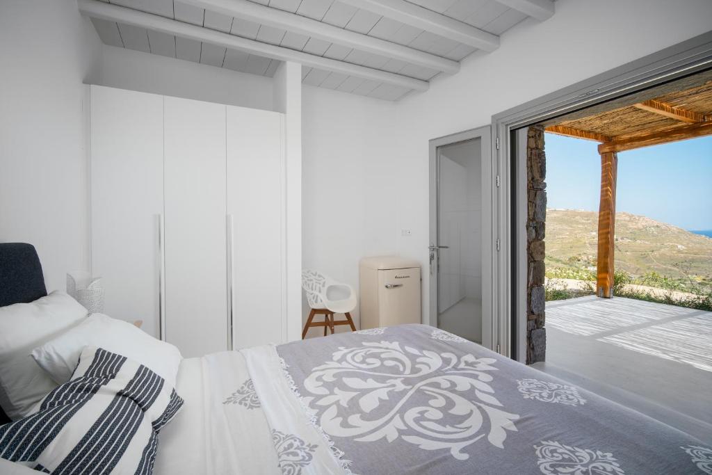 a bedroom with a bed and a view of the ocean at Blue Sea Villa in Serifos Chora