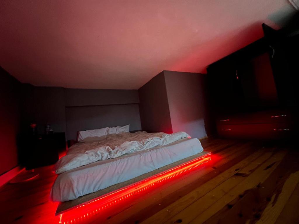a bed in a room with a red light at Abbasaga, Besiktas in Istanbul